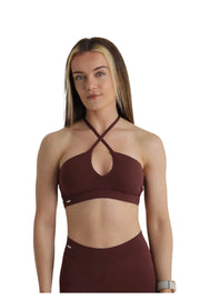 A woman in a Vision Collection Cross Front Bra in Warm Chocolate, showcasing the supportive and flattering design with a cross-front style. Sizes: S, M, L.