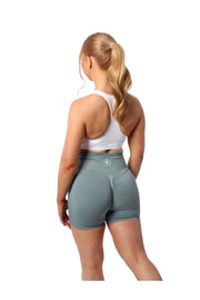 Woman in Nakd Scrunch Collection gym shorts, showcasing curve-enhancing style and flexibility for active workouts.