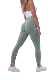 A woman wearing scrunch bum gym leggings and white sneakers, showcasing high-waisted support and butt lift enhancement.