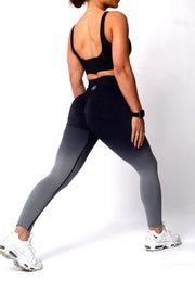 A woman wearing Ombre Collection scrunch bum gym leggings, showcasing a close-up of her leg and shoe.