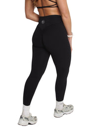 A woman wearing high waisted scrunch bum leggings with honeycomb texture, showcasing close-ups of shoes.