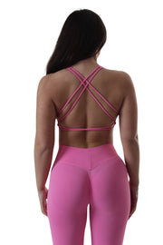 Woman in pink tights and Cross Back Bra from Self Love Collection by Jessica West, showcasing workout style and confidence.