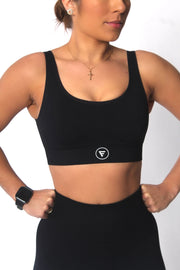 A woman wearing a high impact sports bra from the Staple Collection.