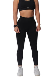 Woman in high-waisted scrunch butt gym leggings from Summer Luxe Collection, showcasing sleek workout attire for confident fitness routines.